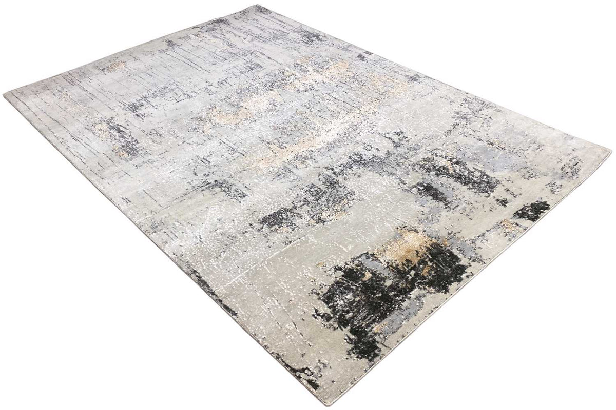 Rectangular rug with an abstract gray-black pattern, light beige base surface