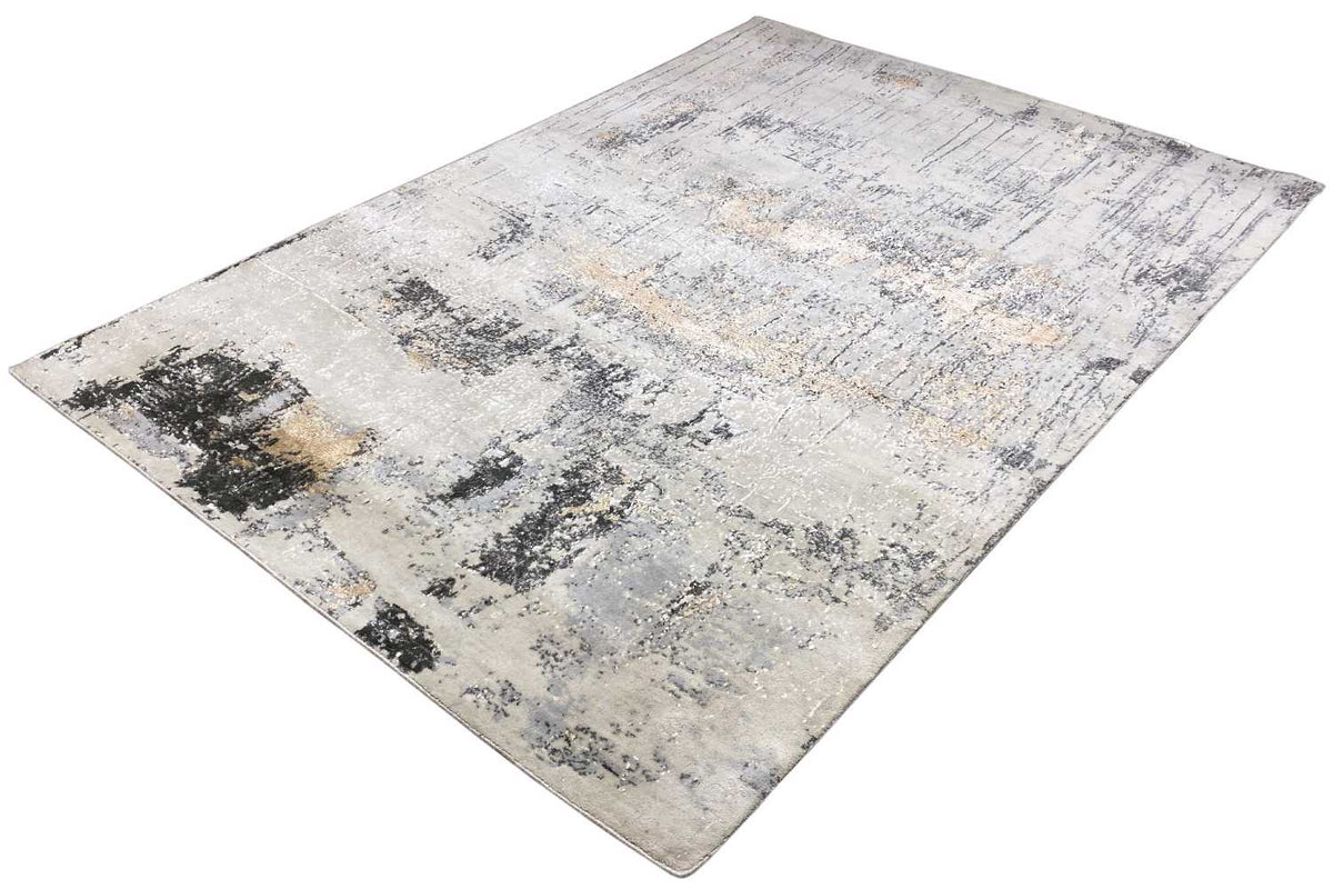 Rectangular rug with abstract spots in light beige and gray, details in black
