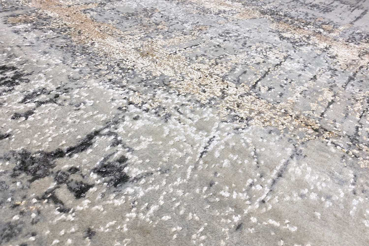 Close-up: abstract pattern of light beige, gray, and black dots and blotches