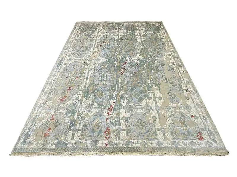 Large designer rug laid flat, vintage pattern in gray, beige, and blue