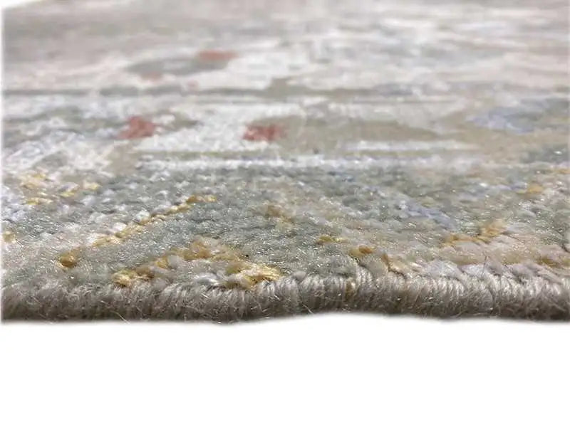 Designer rug close-up, patterned pile in shades of gray, beige, and gold