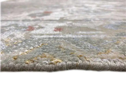 Designer rug close-up, patterned pile in shades of gray, beige, and gold