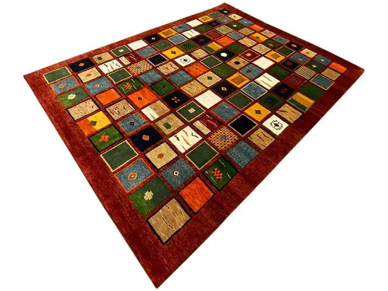 Gabbeh rug “Lori” (256x196 cm) made of colorful tiles with a red border and white accents