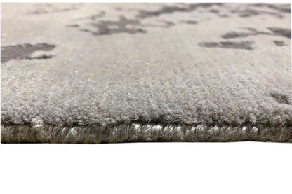Close-up of the rug edge: dense, short pile with a gray gradient effect