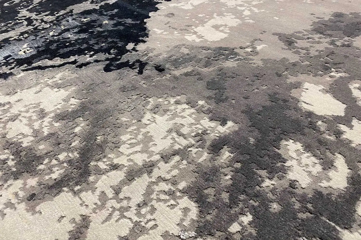 Carpet surface in light cream-gray with dark contrasting pattern elements