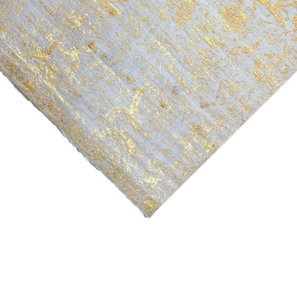Designer rug 316x245 cm, detail of the diagonal edge with a gold-colored ornamental pattern