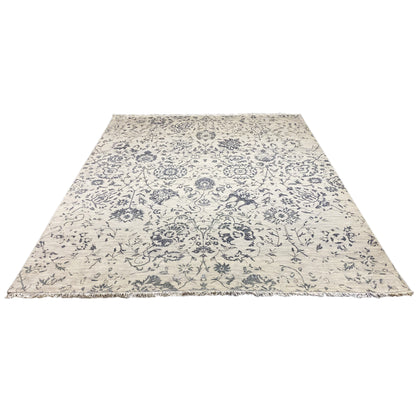 Rectangular designer rug with blue and light-colored ornaments, lying flat