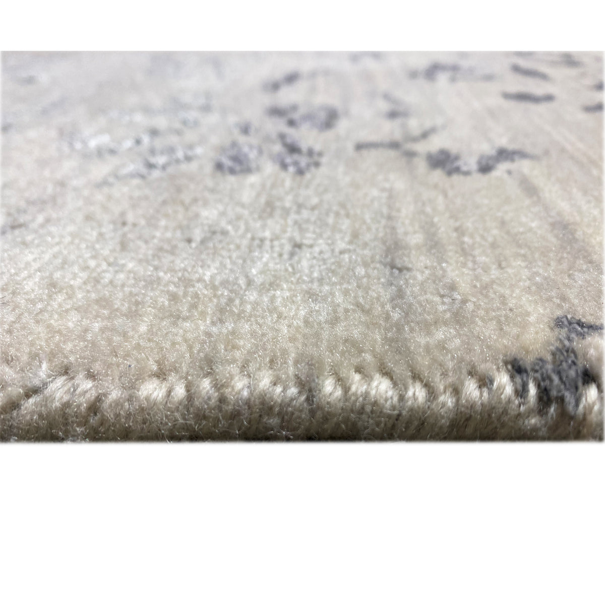 Detailed view of the carpet surface and looped pile structure at the edge
