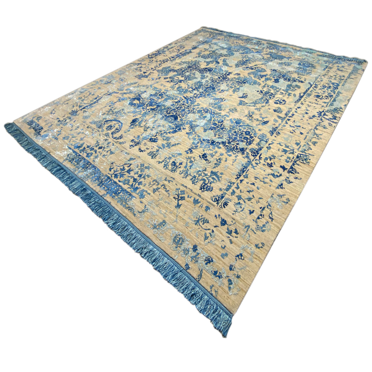Rug in oblique view with a beige background, blue pattern, and blue edge border