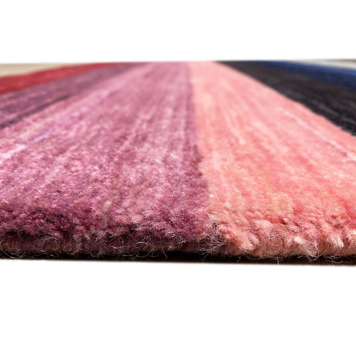 Carpet surface with mottled pile in pink, burgundy and dark blue