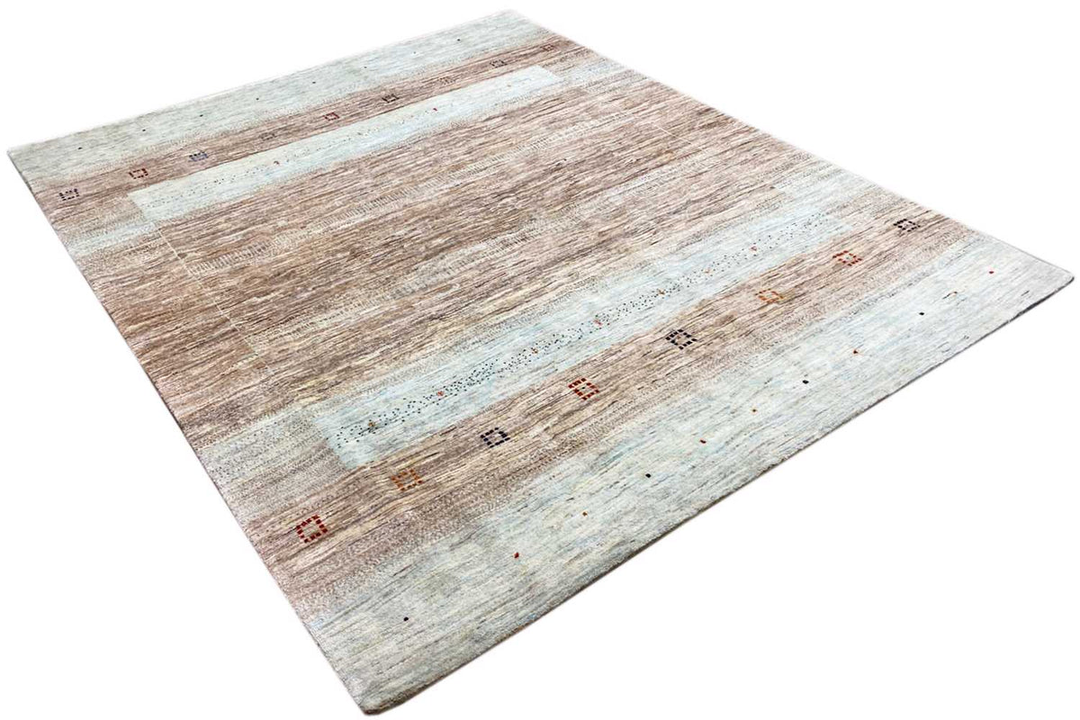 Gabbeh rug from an angled view: vintage stripes in brown, beige, and light blue