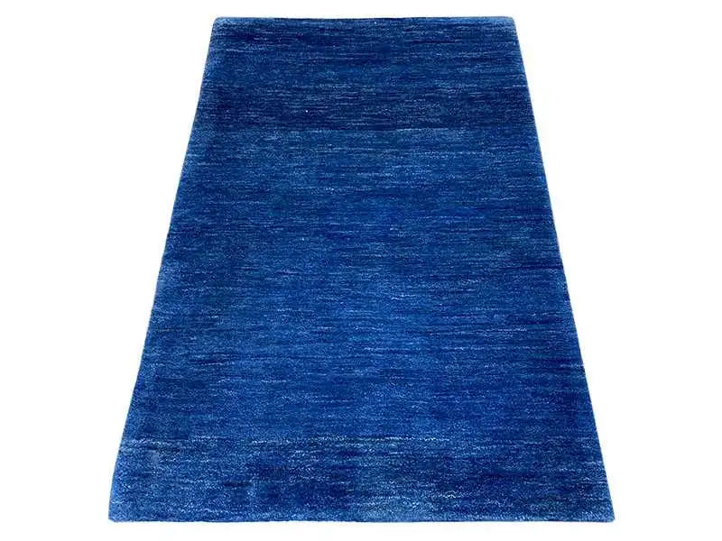 Blue Gabbeh rug with a short, mottled pile.