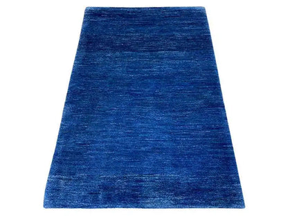Blue Gabbeh rug with a short, mottled pile.