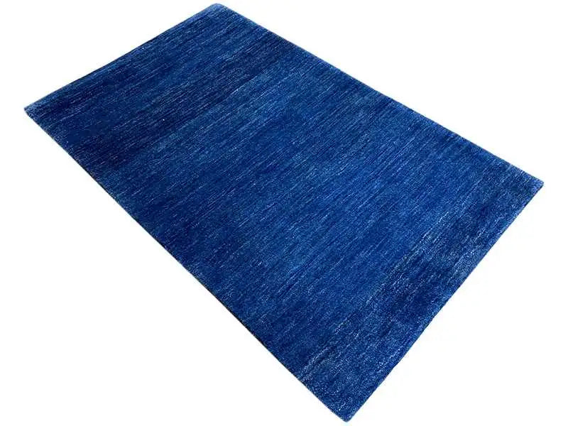 Blue Gabbeh rug, rectangular, with a mottled pile pattern.
