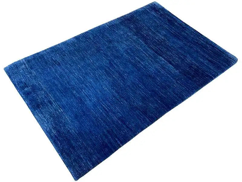 Blue Gabbeh rug with an even, mottled pile pattern.