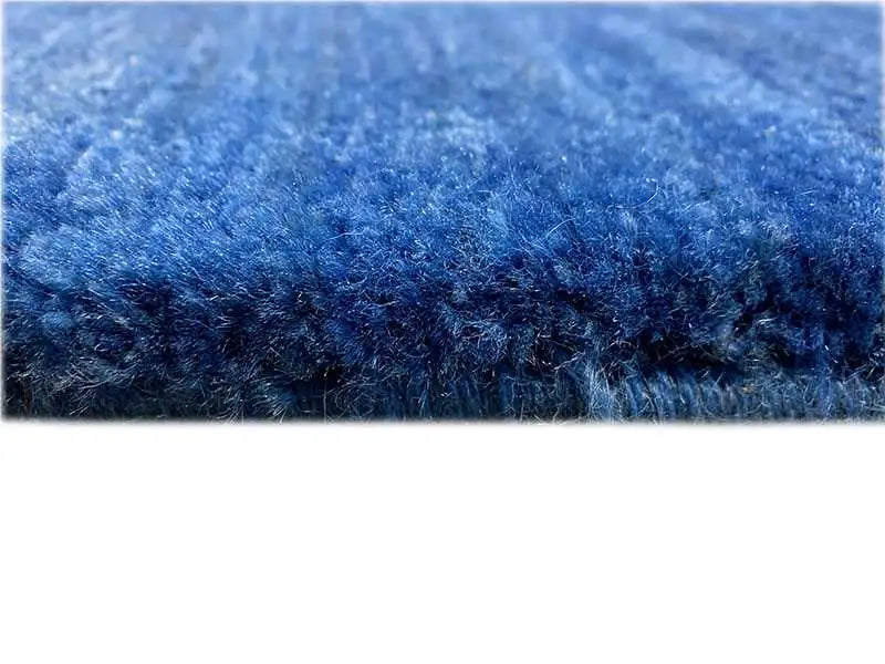 Detail of the edge: blue Gabbeh rug with a dense, short pile.