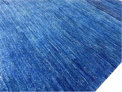 Close-up of the surface: blue Gabbeh rug with a mottled texture.