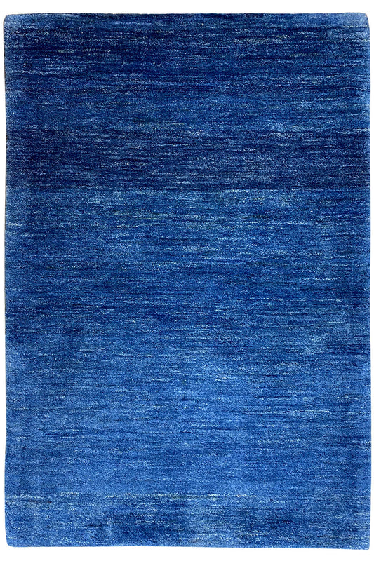Blue rectangular Gabbeh rug with a short, even pile.