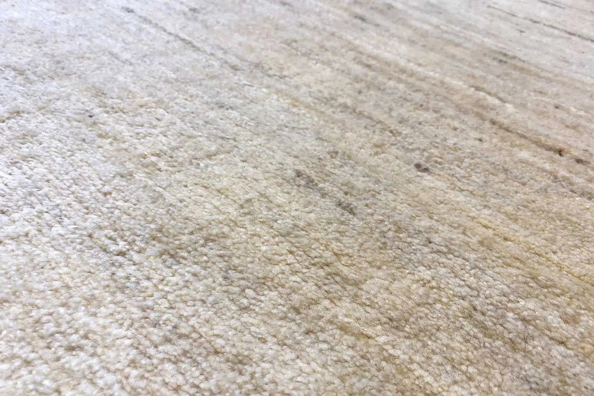 Gabbeh rug detail, natural beige texture with fine, irregular lines