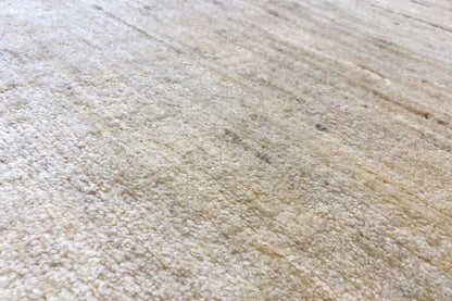 Gabbeh rug detail, natural beige texture with fine, irregular lines