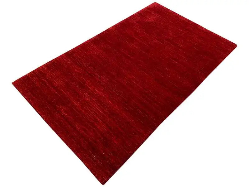 Gabbeh rug 161x93 cm, dark red, laid at an angle, mottled surface