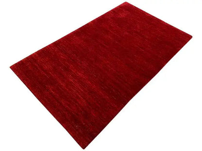 Gabbeh rug 161x93 cm, dark red, laid at an angle, mottled surface