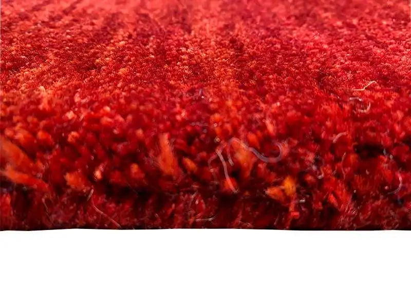 Gabbeh rug, dark red pile texture in detail, finely mottled