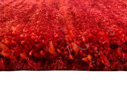 Gabbeh rug, dark red pile texture in detail, finely mottled