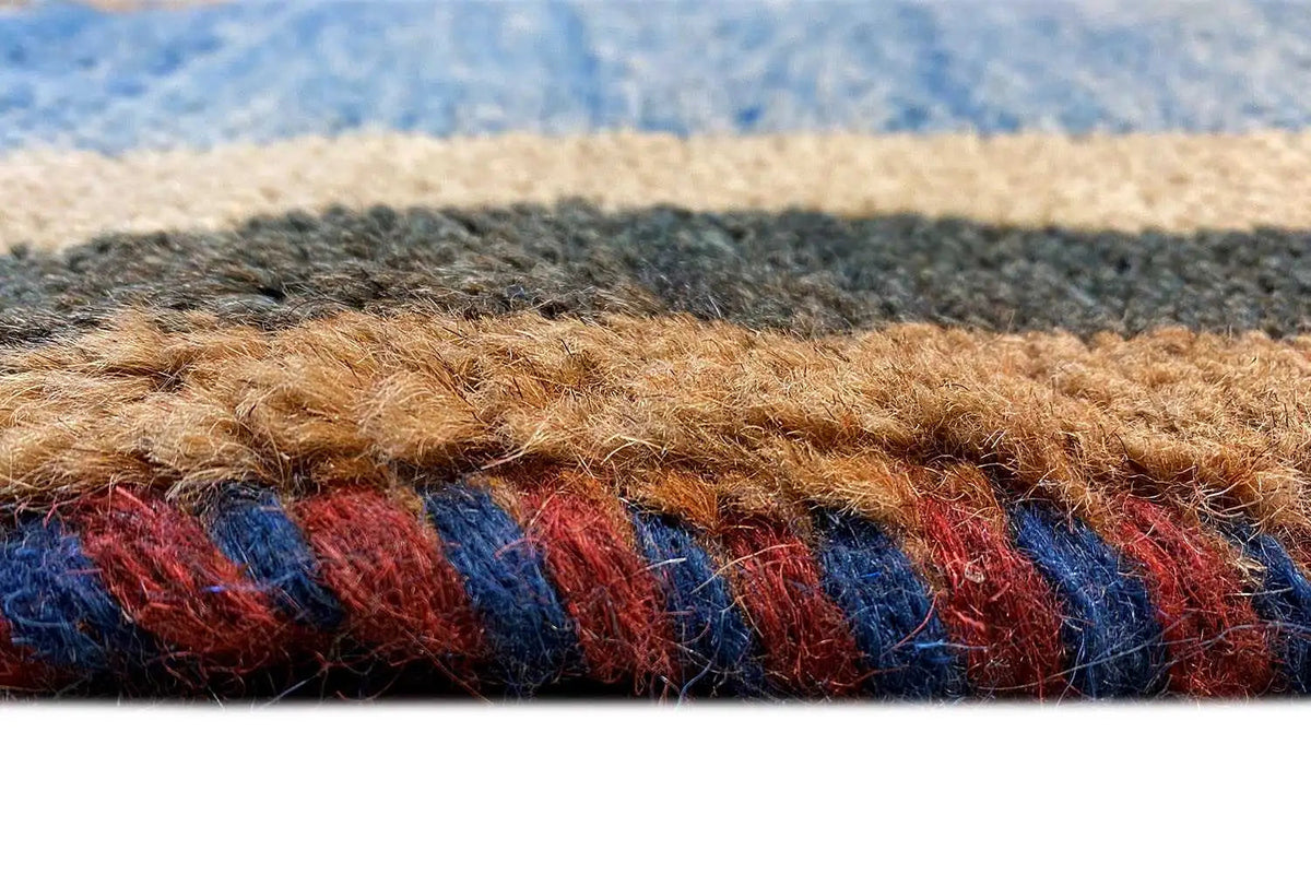 Carpet detail: blue fabric with multicolored threads and a patterned border