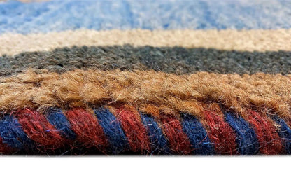Carpet detail: blue fabric with multicolored threads and a patterned border