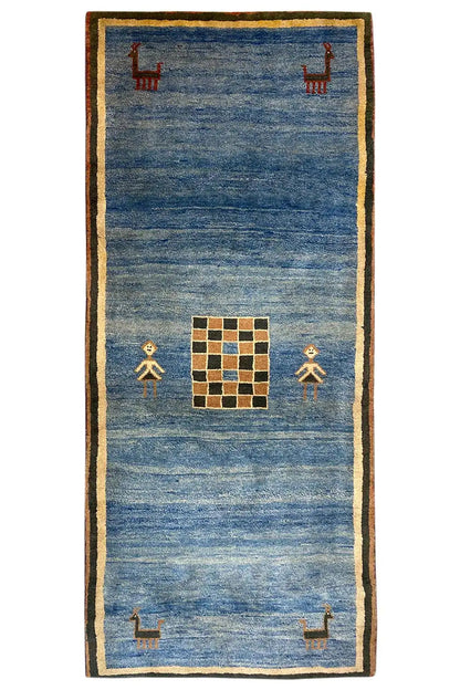 Blue Gabbeh rug with beige border, figures, and medium square pattern