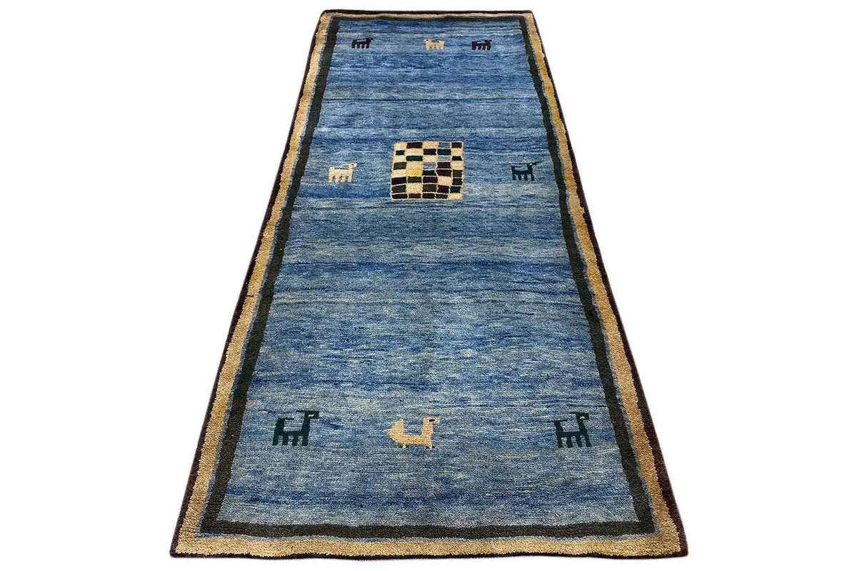 Blue Gabbeh rug with a beige border, patterned square, and small animal motifs