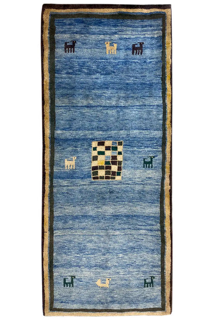 Blue Gabbeh rug with a beige border and a checkered square in the center