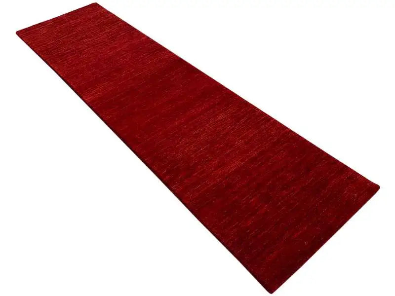 Runner rug in bold red, positioned diagonally
