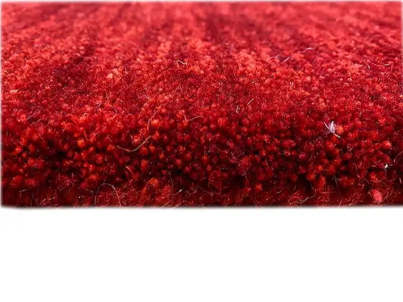 Close-up: red runner rug with a fine, dense pile texture