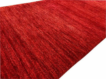 Close-up: red runner rug with a distinctive mottled surface