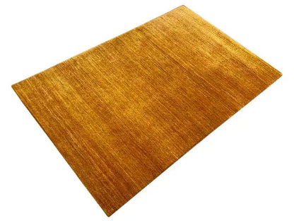 Ocher rectangular rug, viewed from above, with an even pile texture