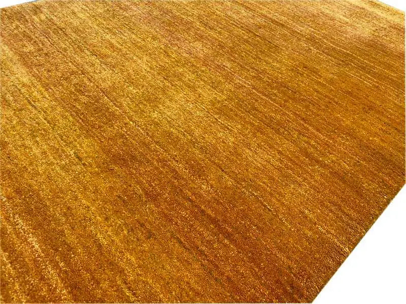 Close-up of an ochre carpet, fine lines in the pile, velvety surface