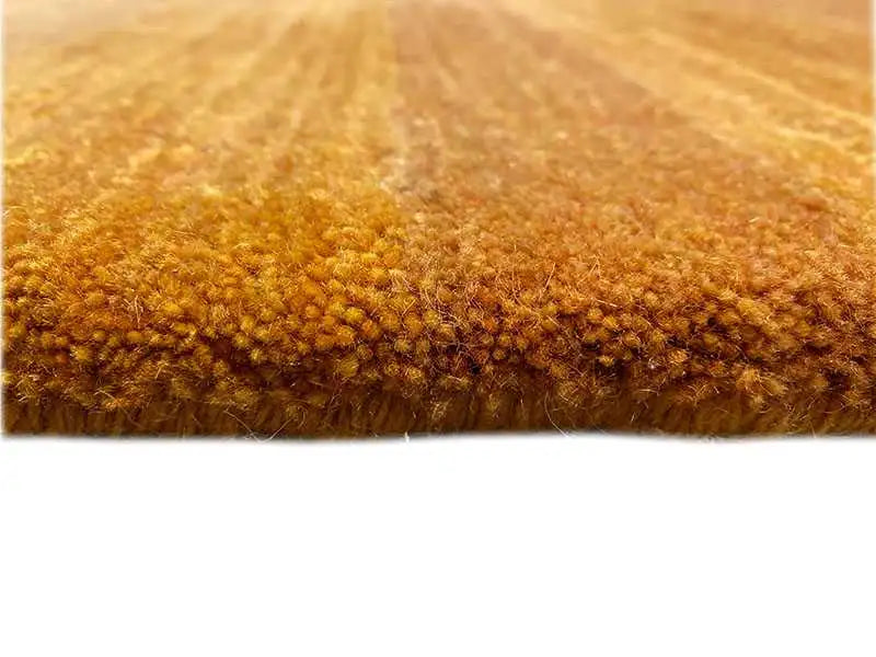 Gabbeh rug close-up: dense, short pile in honey brown, even surface