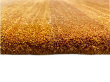 Gabbeh rug close-up: dense, short pile in honey brown, even surface