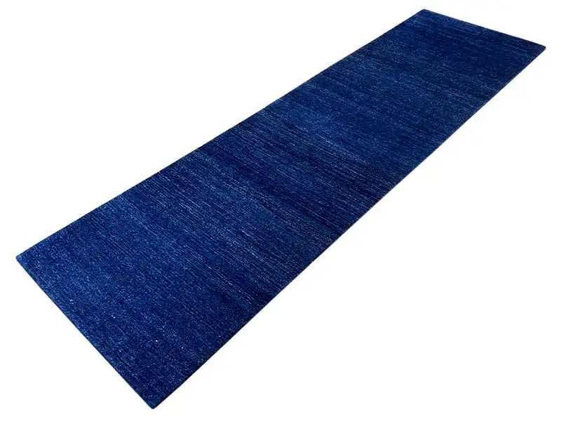 Blue runner rug with a simple, mottled surface and subtle horizontal line texture