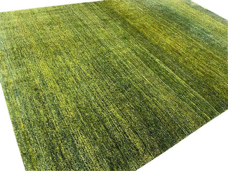 Gabbeh rug detail: green, mottled pile with a fine, directional-looking pattern