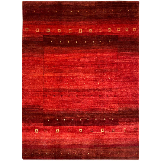 Hand-knotted Gabbeh rug with a red pattern, dark border, and gold accents