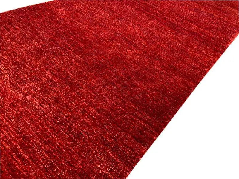 Gabbeh runner rug, dark red mottled finish with a fine pile texture