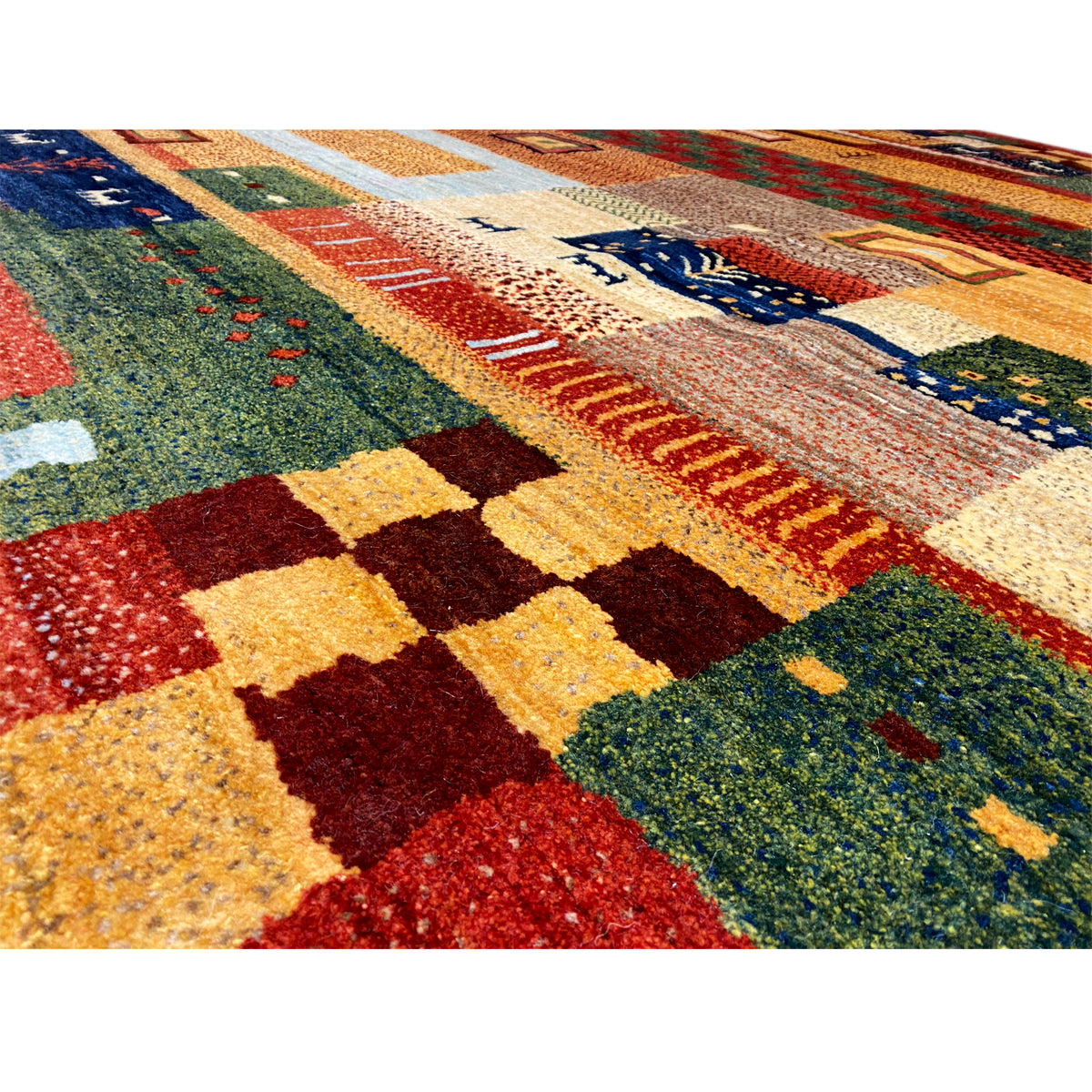 Close-up of a Gabbeh rug: textured pile with color blocks in red, green, and yellow