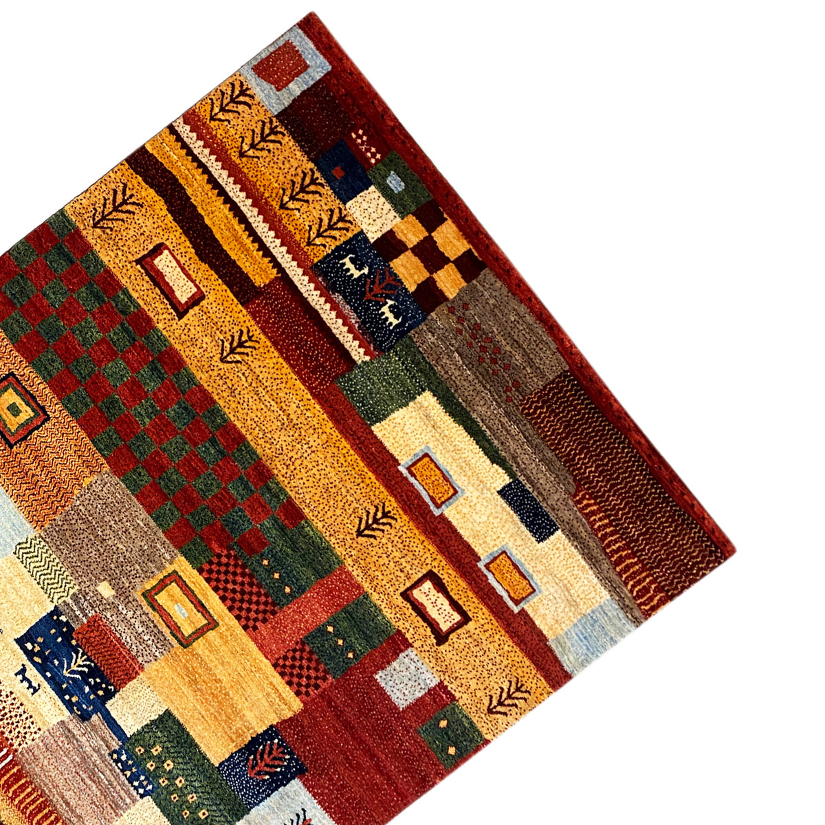 Gabbeh rug corner with patchwork motifs and a colorful fringe border