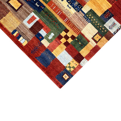 Gabbeh rug in corner view: geometric patterns and pile structure at the edge