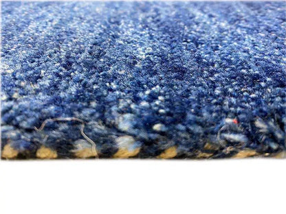 Blue Gabbeh rug 150x100 cm, close-up of the pile and deep-blue edge fringe