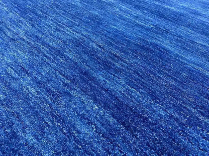 Blue Gabbeh rug 150x100 cm, close-up: mottled blue pile surface