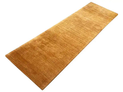 Honey-brown runner rug, rectangular, with a finely mottled surface.